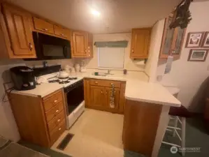well maintained kitchen with microwave, propane stove