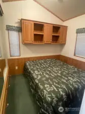 nice size bedroom w/queen bed built-in cabinets and desk area