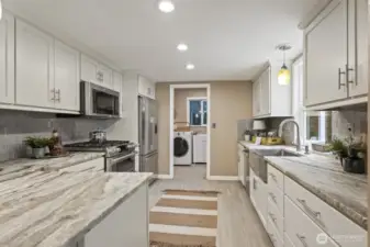 Easy flow from the kitchen to the mudroom/laundry, with convenient access to the garage, carport, and backyard.