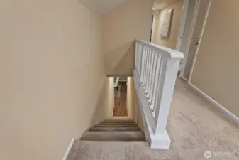 Staircase leads to four additional bedrooms, a second full bathroom, and ample storage.