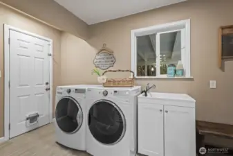 Spacious laundry room/mudroom conveniently located between garage, backyard and kitchen.