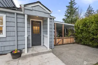 Convenient covered back door off the mudroom/laundry room leads to a spacious extended stamped concrete patio.