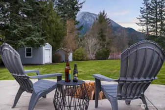 Look out to a fully fenced, level lot offering generous open space — ideal for gardening. Mature landscaping includes blueberry bushes, roses, and willow trees.