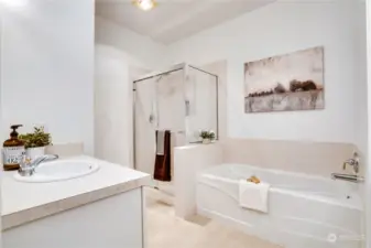 A private 5-piece bath with brand new vinyl flooring offers a tiled shower stall and a soaking tub.