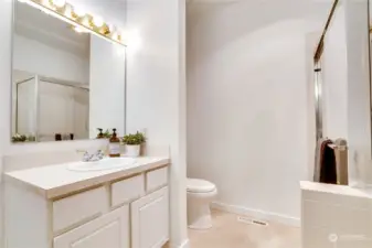 Bright lighting, fresh paint, and brand new flooring complete the private full bath.