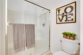 This bathroom has brand new flooring, an easy-to-clean shower surround, and storage under the vanity.