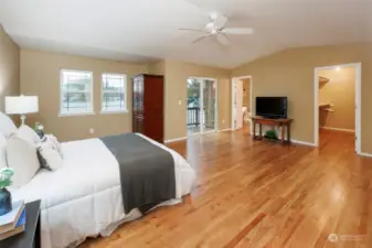 Large primary bedroom with primary bath and walk-in closet.  View of it's own deck.