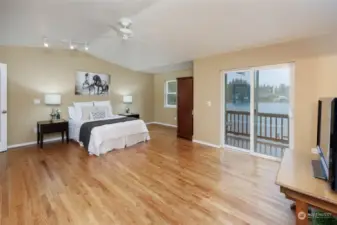 This primary bedroom is a sanctuary with a view of the lake.