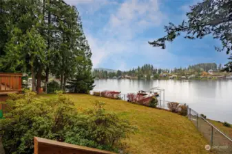 View of the water, fence and docks from deck area.