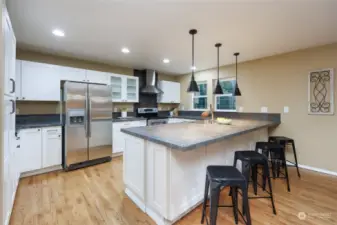 Kitchen has lots of counter and storage space plus stainless steel appliances and a casual eating area.