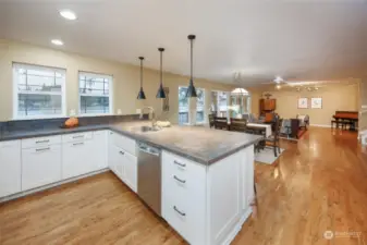 Beautiful kitchen counters and a view of the lake with a full view of the folks in the living room.