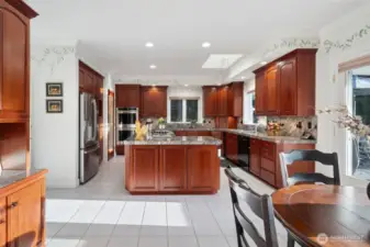 A huge kitchen with stainless steel Refrigerator, double oven, electric cook top, Cherry cabinets, and walk in Pantry.