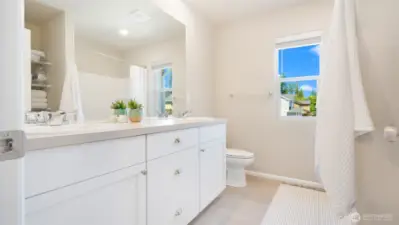The main hall bath is so spacious... and look in the mirror, yes! there are storage shelves here too.