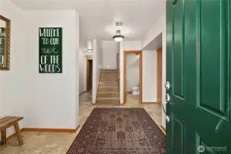 Tiled entry features a half bath and garage access.