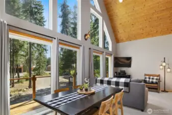 Upstairs you'll find large windows, soaring ceilings, tongue-and-grove paneling, and double sliders face south, filling the house with natural light.