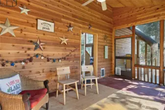 Step through the screen door onto the front deck with firewood storage, perfect for cozy winter days.