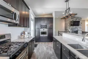 Designer kitchen with custom cabinetry, built-in wine rack, and views straight through to the stone fireplace.