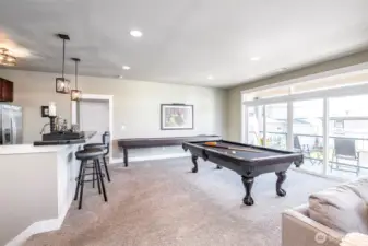Entertain in style with a refined lounge, bar seating, and a full-size billiards table.
