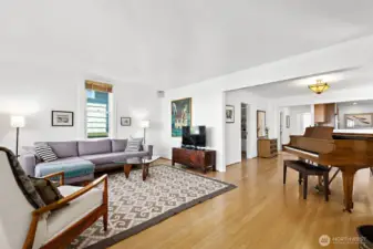 This photo of the living room shows how it opens up to the dining room & kitchen. This open-concept floor plan makes this a great space for entertaining.