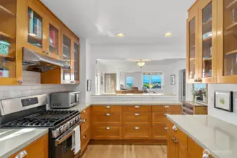 The kitchen features plenty of prep & counter space to please the chef. Here you can see the generous amount of cupboard and under-cabinet storage at hand. The gas range is high quality and newer.