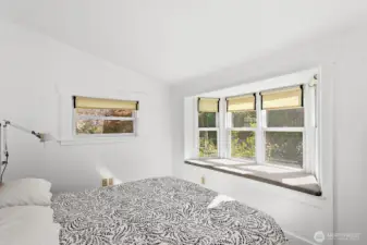 Again, the primary bedroom has a window seat overlooking the gardens.