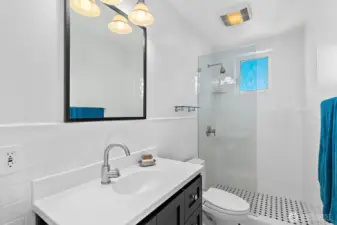 This primary bathroom is at hand to the primary bedroom and features classic, period tile and vanity for crisp, clean look.
