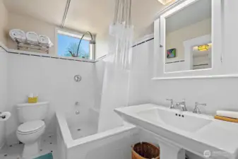 This guest bath is also finished in the period style of white subway-tile keeping both bathroom finishes consistent with each other. This bath features a tub/shower combination which is always nice to have.