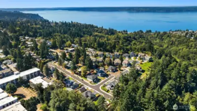 Drone shot of community and reference of closeness to the water. Longer road highlighted in the photo is 13th Pl SW.