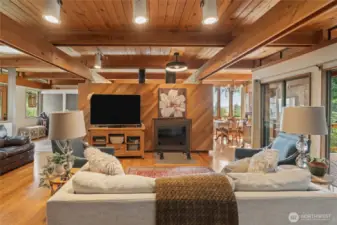 Huge living room open to dining with  wood burning fireplace and access to back deck
