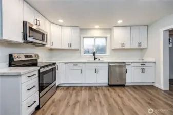 Gorgeous kitchen: Quartz counters, SS appliances, and tons of storage.