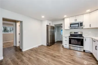 Kitchen leads to pantry to the right and additional bedroom & bath to the left.