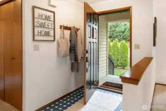 A sunlit entry opens to soft views of the surrounding greenery bringing a hint of the home’s pastoral setting indoors.