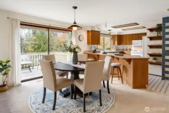 Sunlight fills the dining area and kitchen while sliding doors open to the elevated deck drawing the pastoral landscape into the heart of the home.