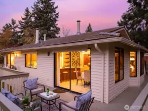 The inviting kitchen connects directly to a spacious deck ideal for outdoor meals and sunset moments above the private pastoral setting.