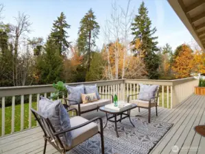 A generous entertaining deck perched above the pastoral grounds provides easy outdoor living and quiet views of the neighboring woodland.