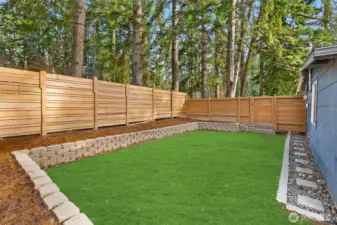 Rear yard. Virtual grass. Can be installed upon request.