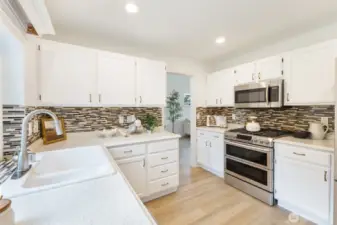 New countertops provide beauty and function, while the new cabinetry offers abundant storage. Stylish backsplash adds visual interest.