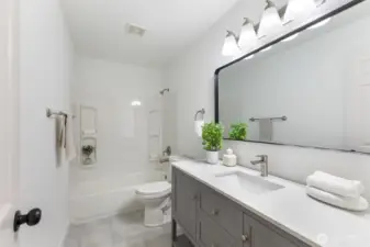 Full bath with tub/shower combo.