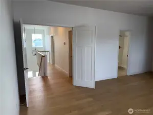 Exit ensuite at top of stairs.  Looking down the hallway, first door is the laundry room, second door is the second ensuite.