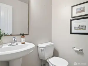 Half bathroom downstairs, discretely tucked back by the garage and laundry room.
