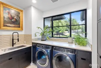 Spacious laundry/mudroom with all, the conveniences you could as for, just adjacent to your walk in pantry.