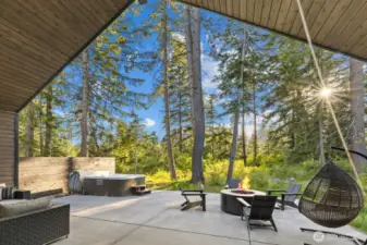 Covered back patio with hot tub and gas firepit.