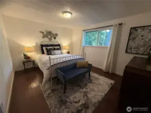 Large bedroom w/ plenty of natural lighting.