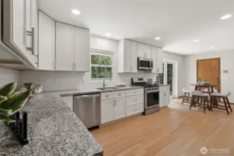 Lots of white modern cabinets & granite counters!