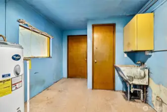 Utility room to back entrance and past 1/5 bathroom