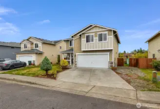 RV or boat parking alongside home (gravel area) seen with side gate open to access the backyard.  Playhouse with slide seen as well.