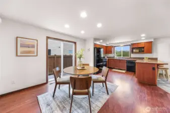 Dining area and kitchen.  Notice the eating bar area to your right.  Granite tile counters and new microwave with all appliances included.  Living room to your right.