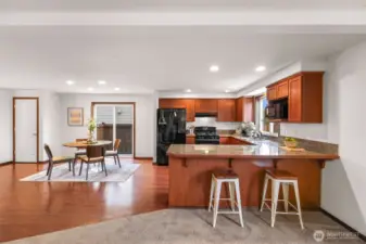 Another view of the closet (left), the dining area & slider, and kitchen with eating space.