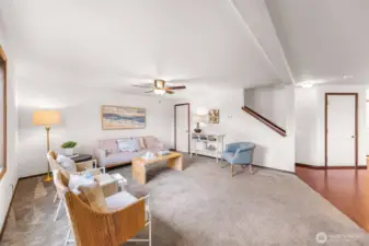 Large window to your left plus an under the stairway closet (door) seen at center.  Interior garage entrance/exit door seen to the right.