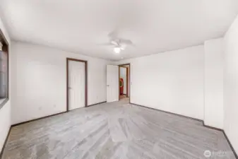 Another view of bedroom #1.  Walk in closet door at center, entry and laundry room seen in the background.